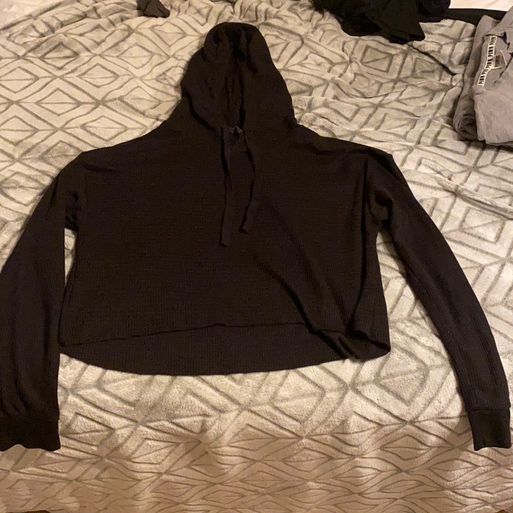 A small black long sleeve sweater.